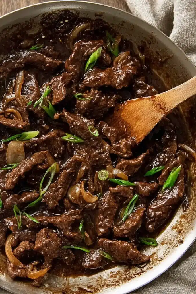 Overhead view of beef stir fry with honey pepper sauce and scallions