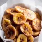Easy Cinnamon Air Fryer Banana Chips – Quick & Amazing 10 easy Cinnamon Air Fryer Banana Chips in a white bowl on gray table