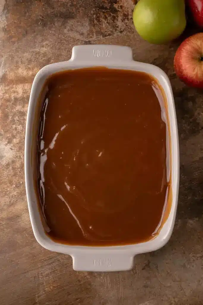 easy caramel apple cheesecake dip recipe with caramel layer in white dish