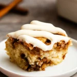 Cinnamon Roll Cake with Cream Cheese Frosting slice on white plate