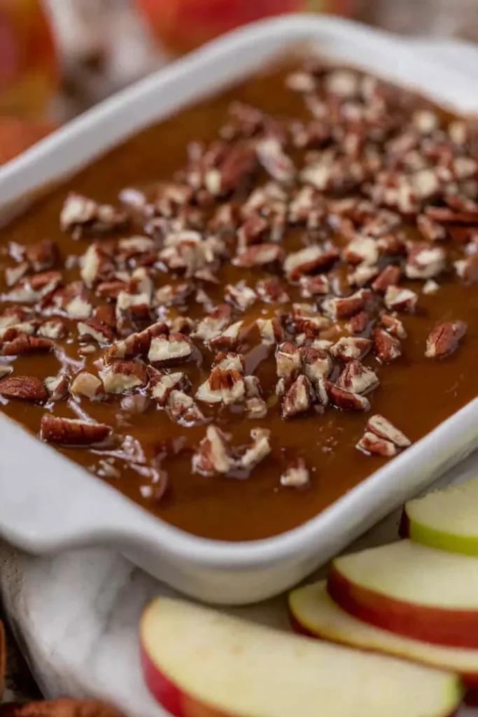 easy caramel apple cheesecake dip recipe topped with pecans and served with apples
