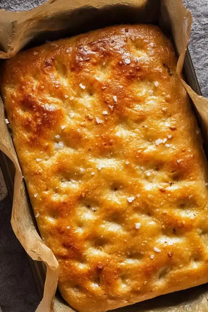 Golden quick and dirty focaccia baked in a parchment-lined pan