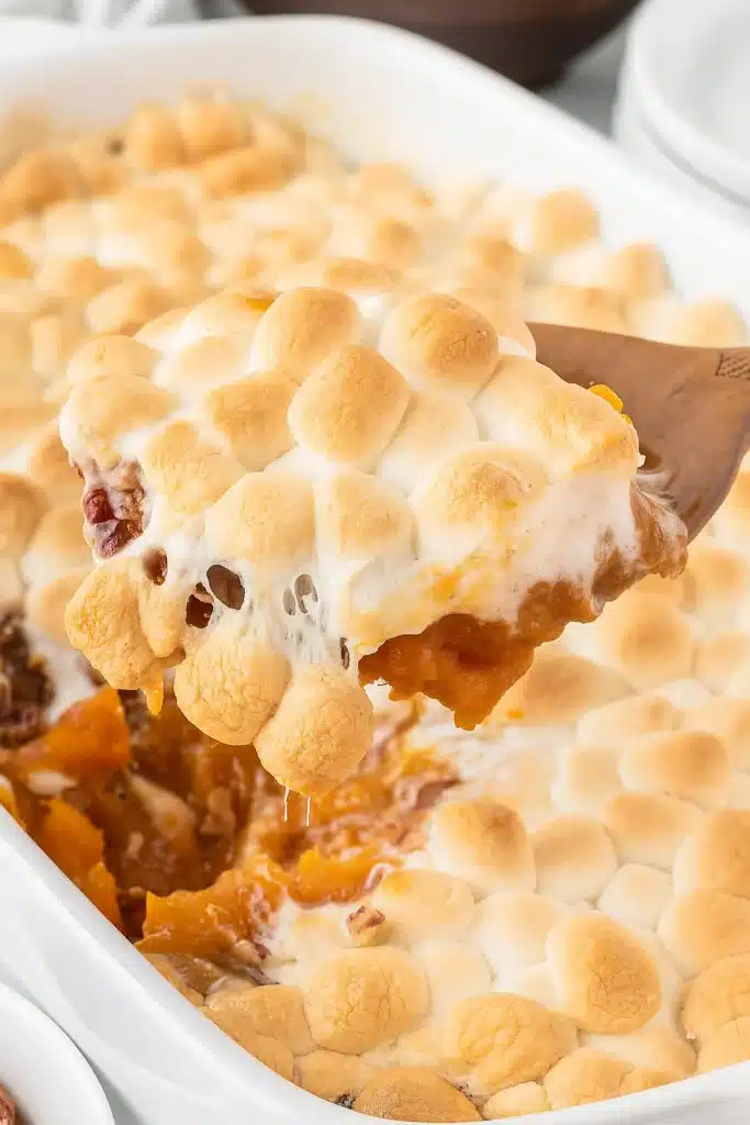 Sweet Potato Casserole with Marshmallows being served from a baking dish