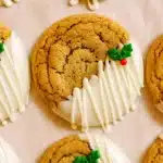 Chewy maple cinnamon cookies dipped in white chocolate with holly sprinkles