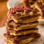 Christmas Crack Recipe – Irresistibly Easy Holiday Candy 14 Stack of Christmas Crack saltine toffee with chocolate and pecans tied with holiday string