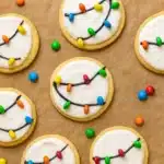 Christmas Lights Cookies – Easy, Festive, and Fun 11 Christmas Lights Cookies on parchment with colorful candies and white icing
