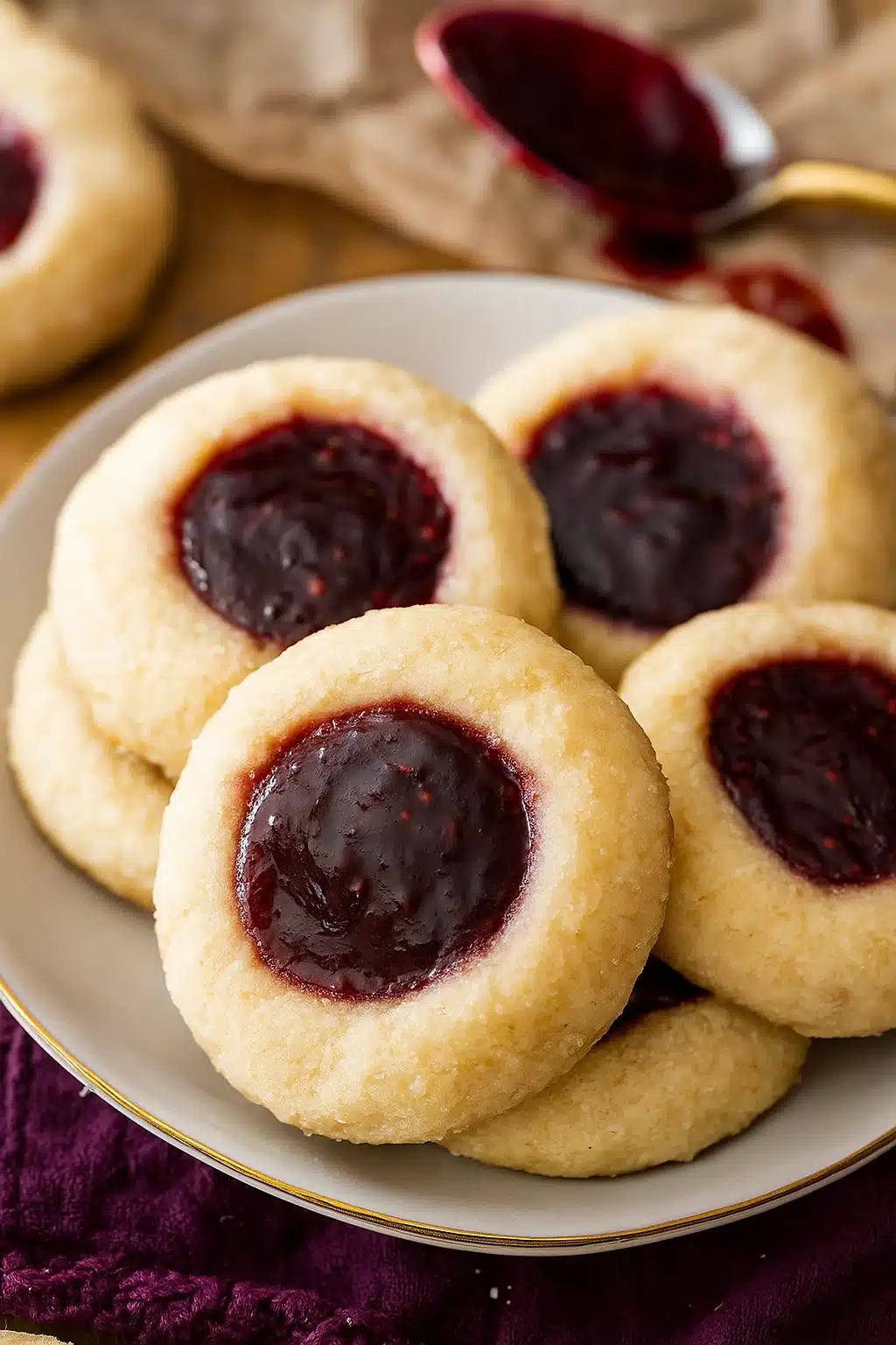 Classic thumbprint cookies with raspberry jam filling on a plate