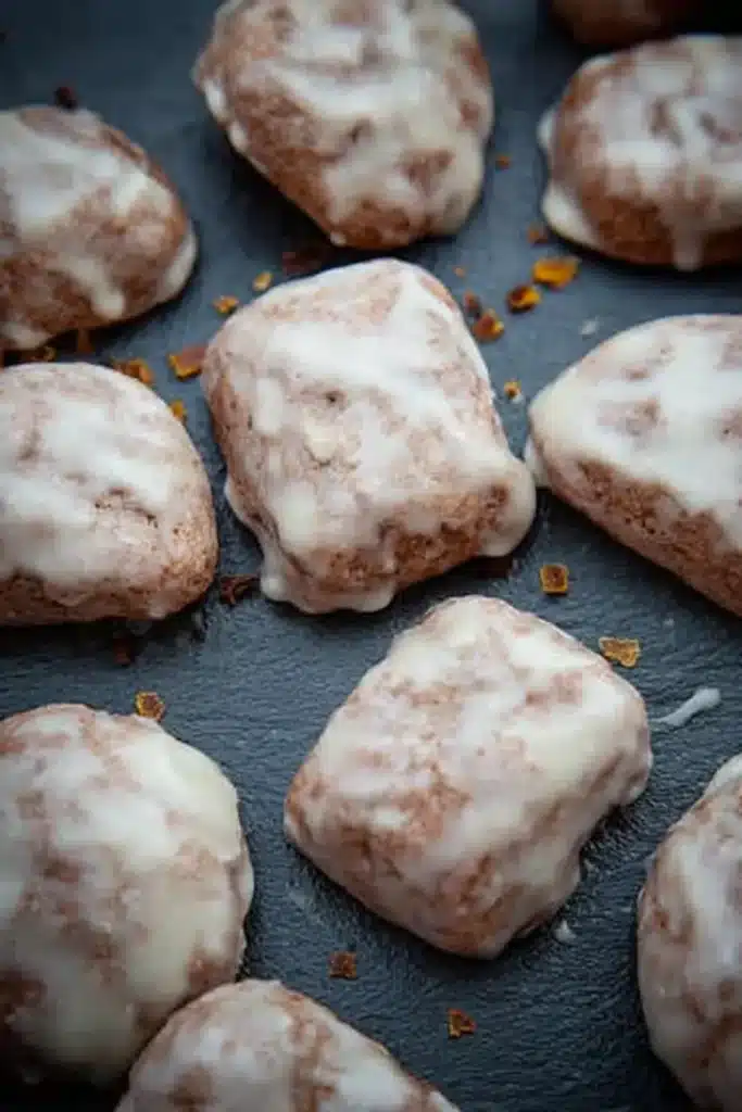 Irresistible Glazed Orange Cookies with Cinnamon & Cloves 8 close-up of glazed orange cookies with cinnamon and cloves on dark slate