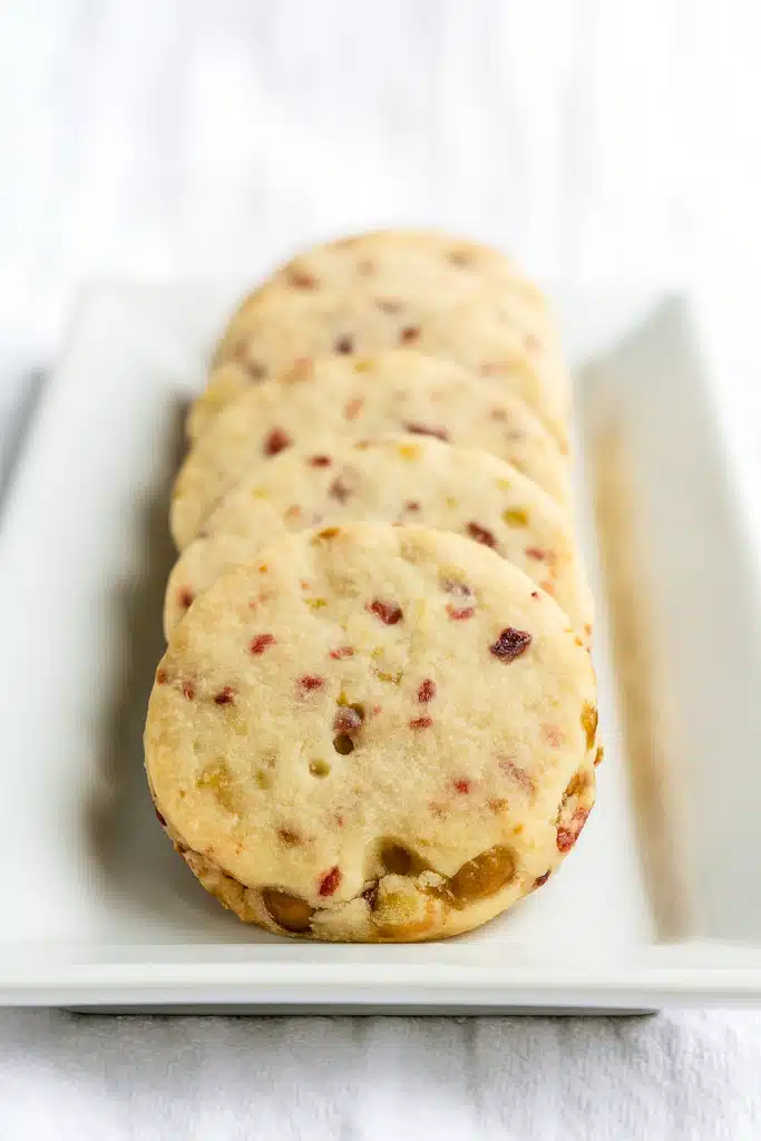 Cranberry pistachio shortbread cookies on a white plate