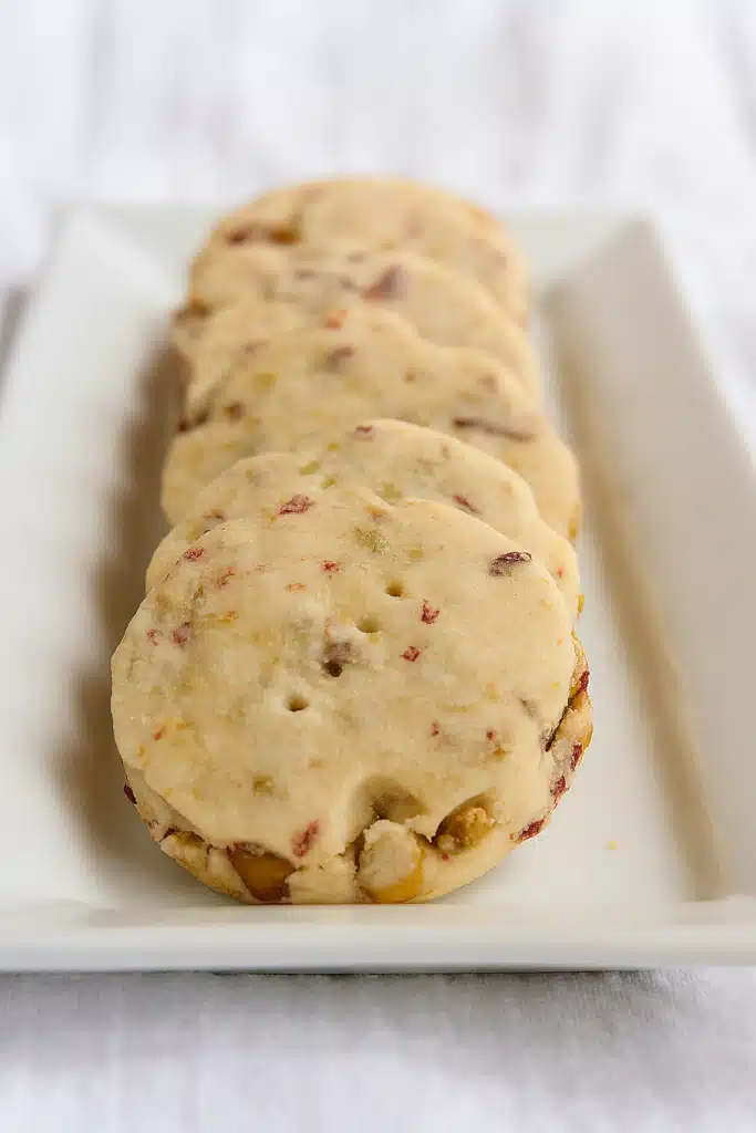 Cranberry pistachio shortbread cookies on a white plate