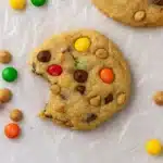 Chewy monster cookie with colorful candies, peanut butter chips, and a bite taken out