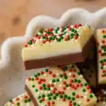 The Best Christmas Fudge | Simple, Festive & Delicious 22 the best christmas fudge Recipe featuring creamy chocolate layers and colorful holiday sprinkles on a festive plate
