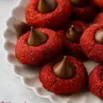 Red Velvet Blossoms Cookies – Easy, Festive & Delicious 20 Red Velvet Blossoms Cookies on a white plate with chocolate centers