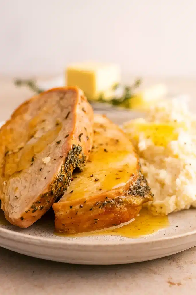 Roasted Turkey Breast Recipe | Juicy & Amazing Flavor 9 Roasted turkey breast slices with creamy mashed potatoes on a plate