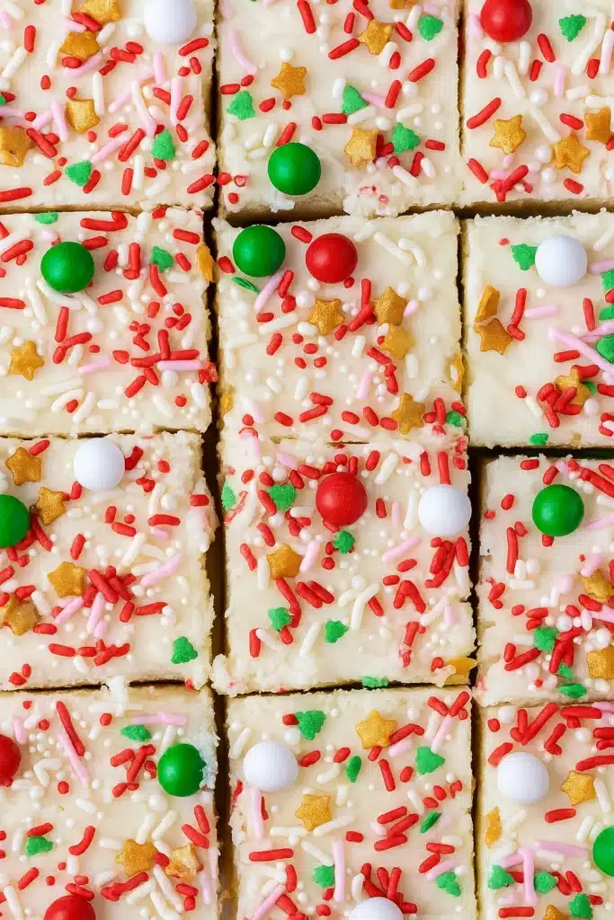 Christmas Sugar Cookie Bars – Soft, Sweet & Irresistible 17 Top view of sliced Christmas sugar cookie bars with frosting and festive sprinkles