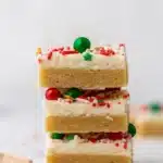 Christmas Sugar Cookie Bars – Soft, Sweet & Irresistible 18 Stack of Christmas sugar cookie bars with frosting and sprinkles