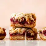 Cranberry Bars Recipe – Amazing Holiday Dessert Magic 8 Cranberry Bars stacked showing buttery crust and cranberry filling