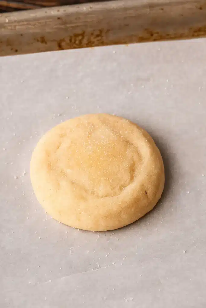 Chewy Sugar Cookies Recipe – Soft, Buttery & Amazing Treat 19 Unbaked sugar cookie dough ball on parchment paper