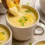 Cheddar cauliflower soup with melted cheese and sourdough bread