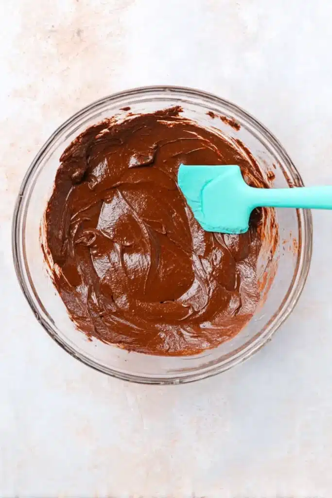 Peppermint Truffles – Easy, Delicious, and Festive Treats 19 Thick chocolate truffle mixture in glass bowl with spatula