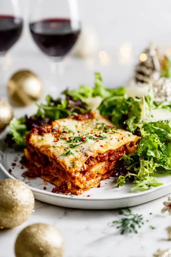 Christmas Eve Lasagna – Festive, Comforting & Delicious 9 Plated Christmas Eve lasagna with salad and festive holiday decor
