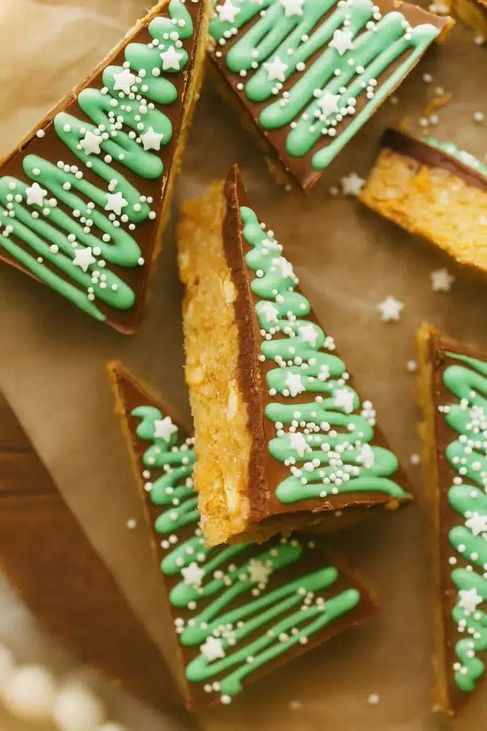 Close up of no bake peanut butter Christmas trees with green icing and sprinkles