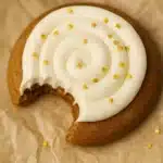 Crumbl gingerbread cookies with cream cheese frosting and gold star sprinkles