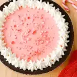 No-bake peppermint pie with whipped cream and crushed candy canes