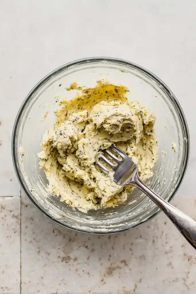 Christmas Prime Rib | Ultimate Juicy & Foolproof Recipe 14 Garlic herb butter mixture in glass bowl with fork