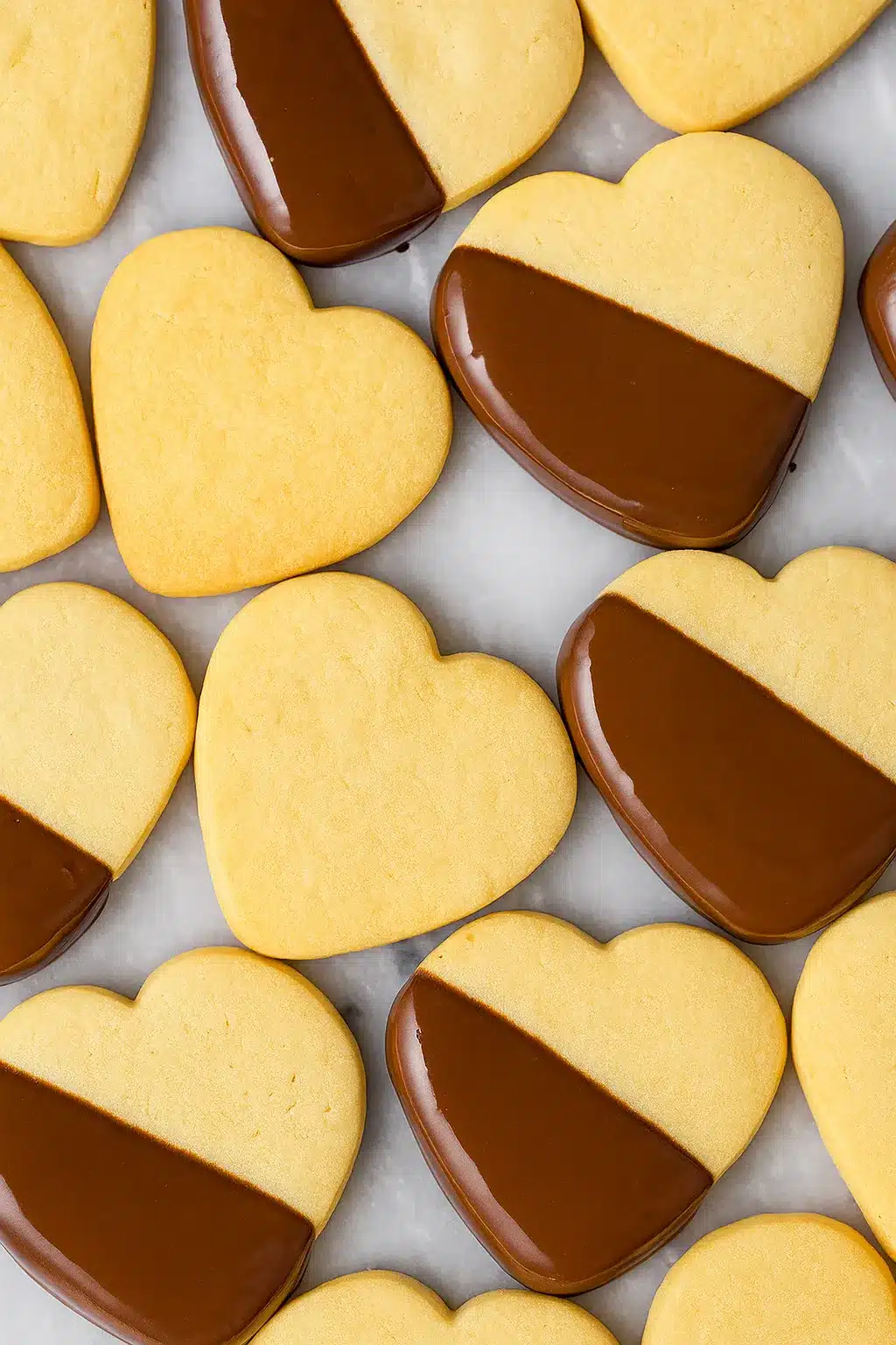 home 9 Heart-shaped shortbread cookies dipped in dark chocolate on marble surface