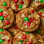 Close-up of chewy Kitchen Sink Christmas Cookies with M&Ms, pretzels, and holiday sprinkles