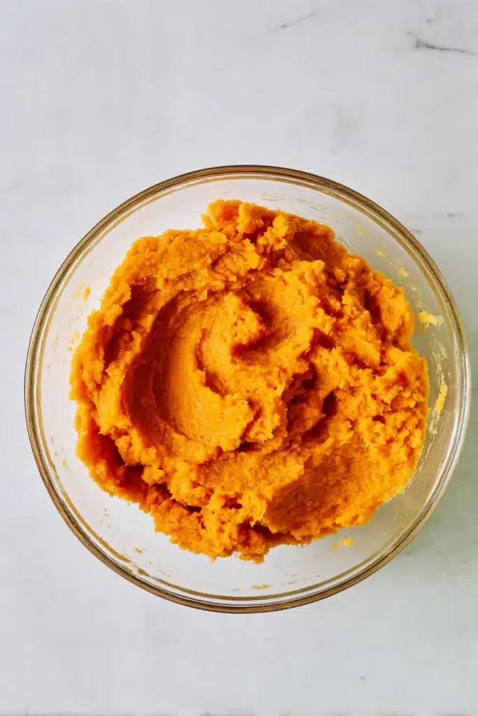 Sweet Potato Pie – Soulful, Creamy & Irresistibly Delicious 16 Mashed sweet potatoes in glass bowl for pie filling