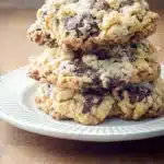 Stack of homemade Neiman Marcus cookies with chocolate chunks on a white plate