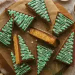 No bake peanut butter Christmas trees with chocolate topping and green icing