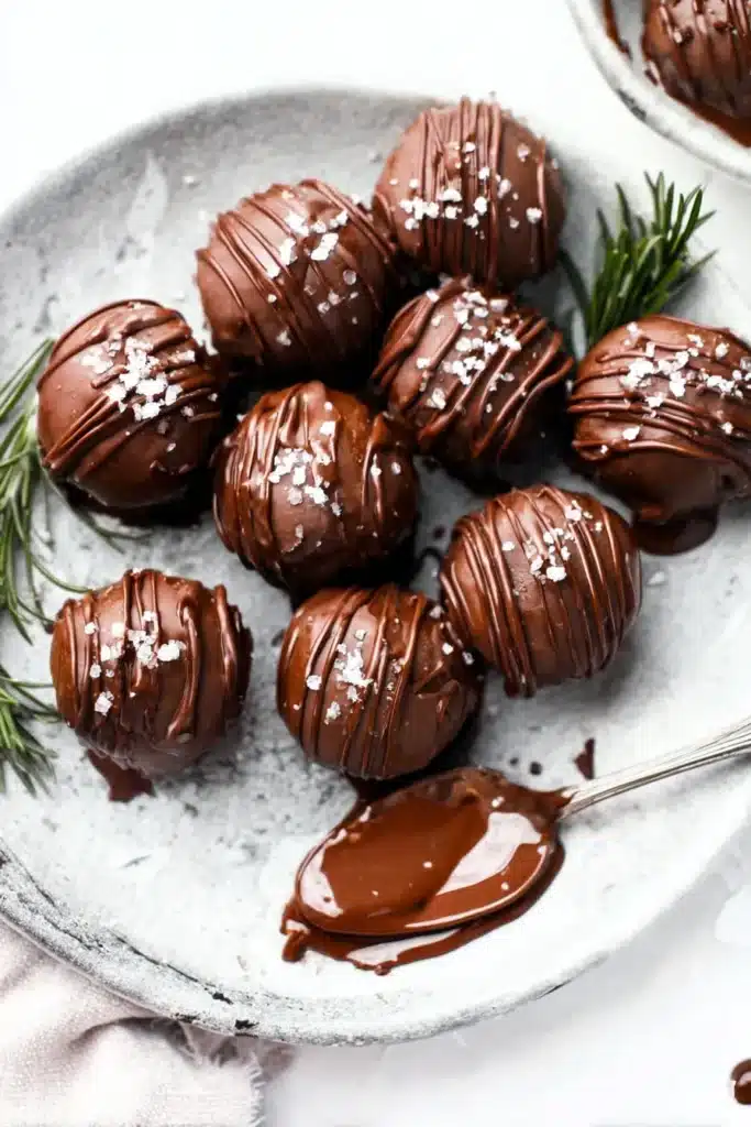 Peppermint Truffles – Easy, Delicious, and Festive Treats 23 Chocolate peppermint truffles with sea salt and chocolate drizzle on marble plate