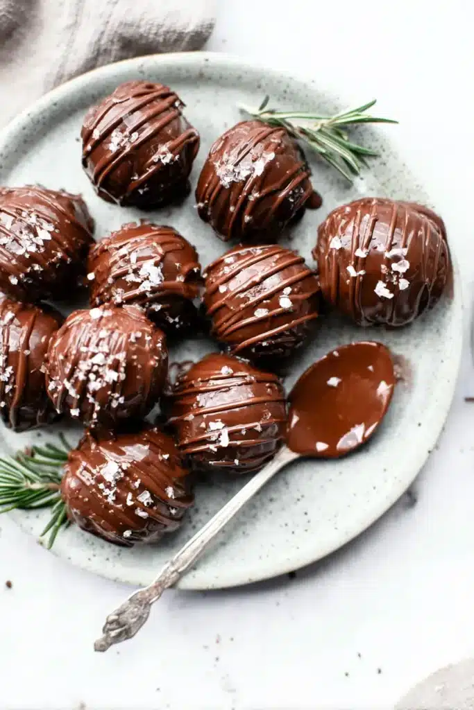 Peppermint Truffles – Easy, Delicious, and Festive Treats 17 Chocolate peppermint truffles with sea salt and chocolate drizzle on marble plate