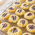 Raspberry swirl shortbread cookies with glaze on cooling rack