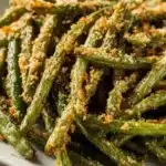 Roasted parmesan green beans with crispy breadcrumb coating on a plate