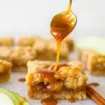 Salted caramel apple crumble bar drizzled with caramel sauce