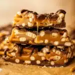 The Best Salted Caramel Pretzel Bark stacked with gooey caramel and chocolate