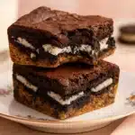 Stacked Slutty Brownies with Oreo layer on a dessert plate