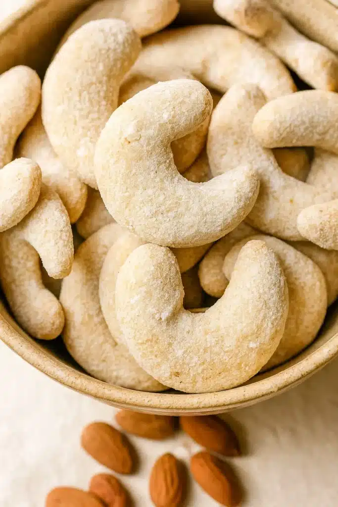Vegan Vanillekipferl Crescent Cookies | Austrian Christmas 7 Close-up of vegan Vanillekipferl crescent cookies with powdered sugar