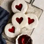 Best Jam Cookies with heart-shaped strawberry filling on a cooling rack