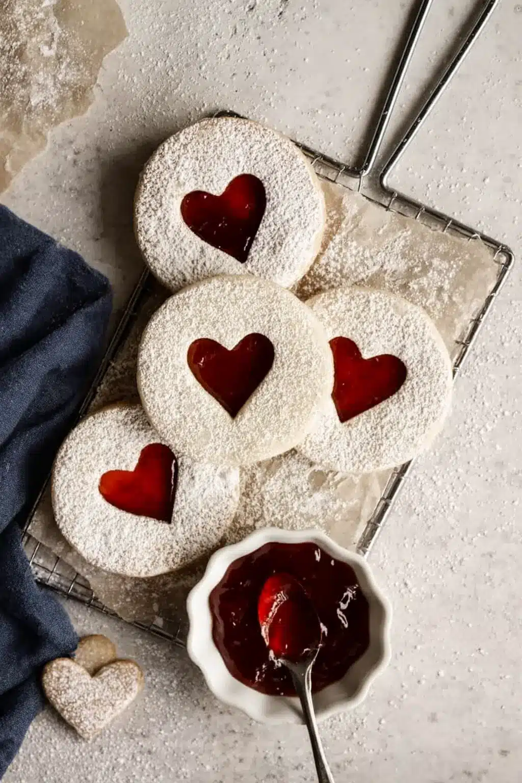 Best Jam Cookies with heart-shaped strawberry filling on a cooling rack