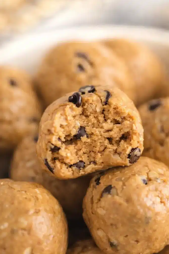 Close-up of a bitten no bake peanut butter protein ball with chocolate chips