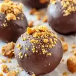 Close-up of Butterfinger Nutter Butter truffles coated in chocolate with candy topping