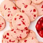 Cherry almond shortbread cookies with maraschino cherries in a white bowl