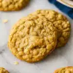 Chewy oatmeal cookies on marble surface with blue napkin