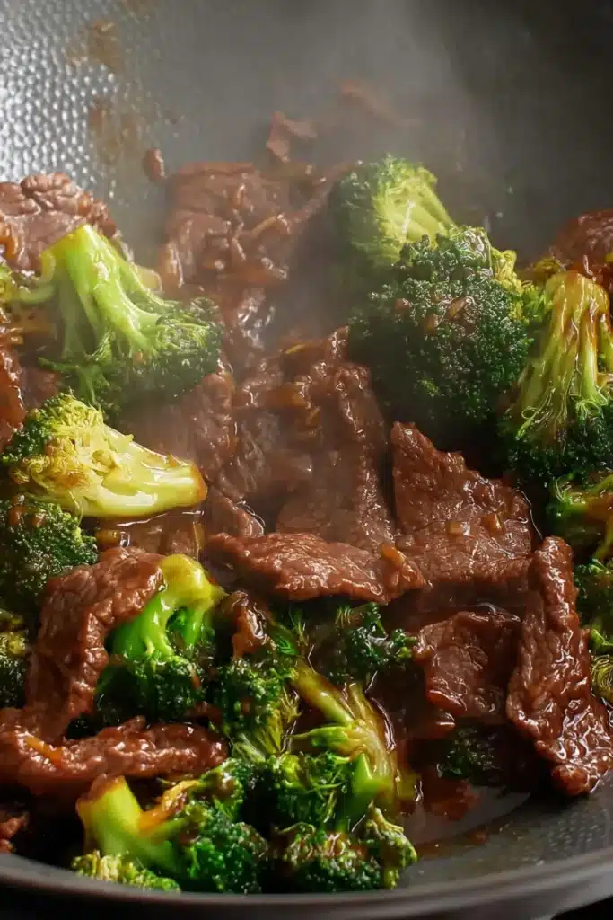 Easy Chinese Beef and Broccoli | Quick & Delicious Dinner 9 Beef and broccoli stir-frying in wok with glossy brown sauce