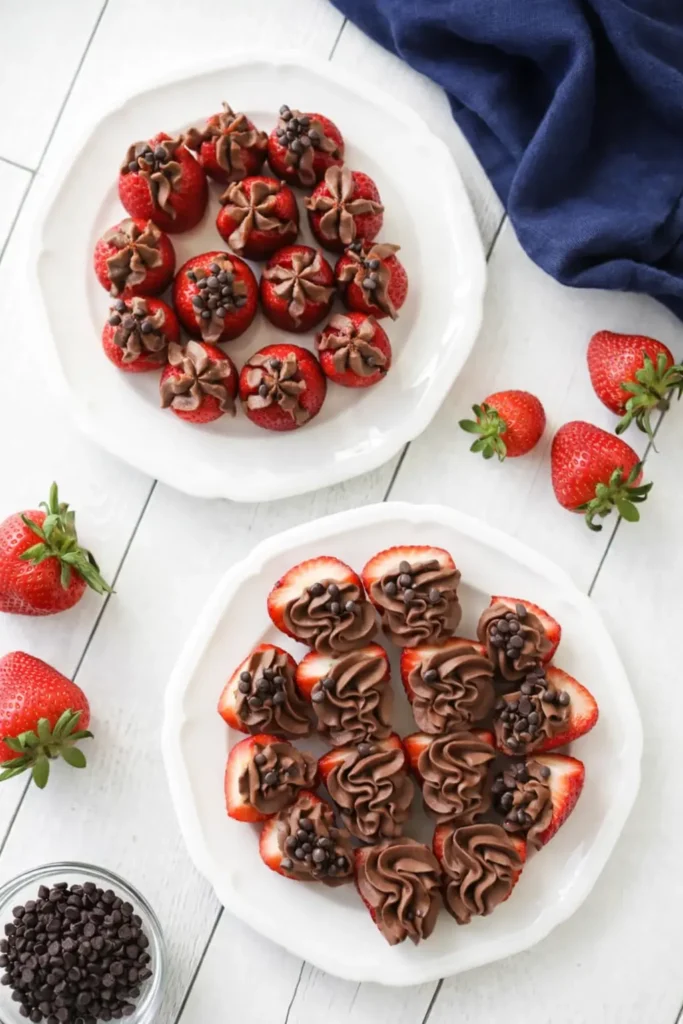 Two plates of chocolate cheesecake stuffed strawberries with navy napkin